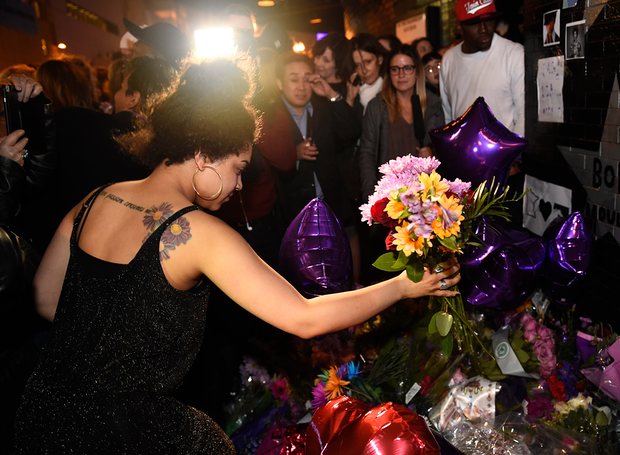 A fan leaves flowers outside First Avenue, the nightclub featured in the movie Purple Rain